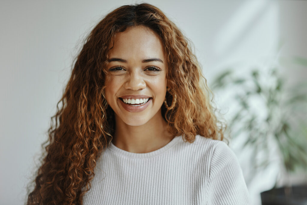 woman with curly hair smiling